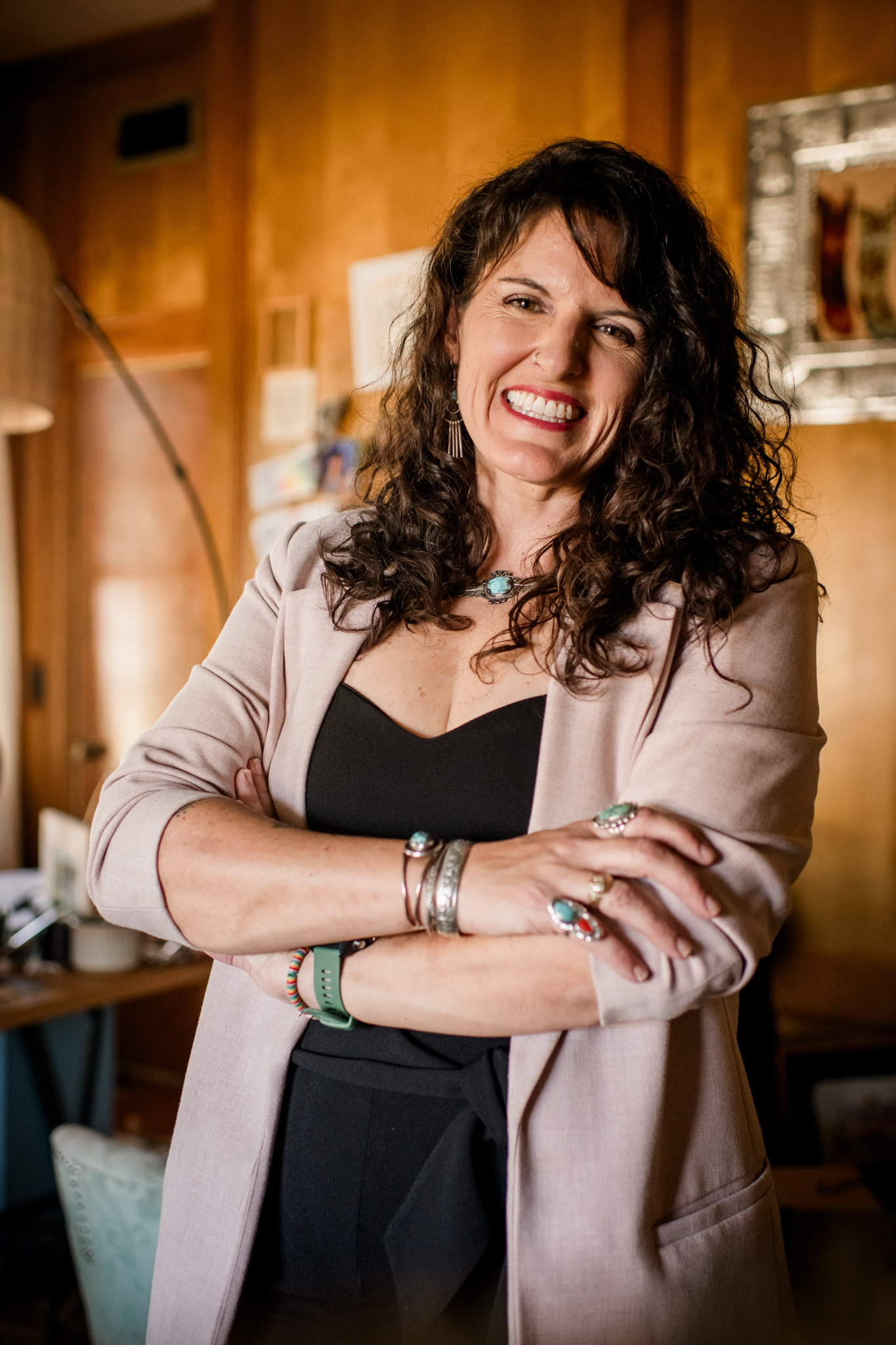 Houston Wedding Photographer Jamie Hardin laying on the floor with her light tan and black dog licking her cheek as she smiles